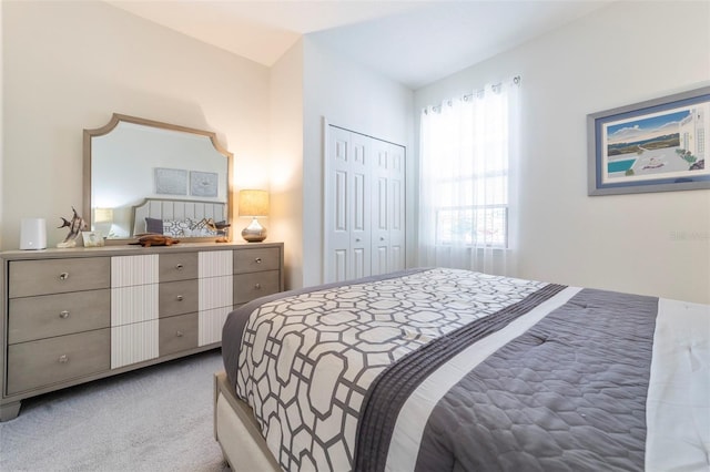 bedroom with a closet and light carpet