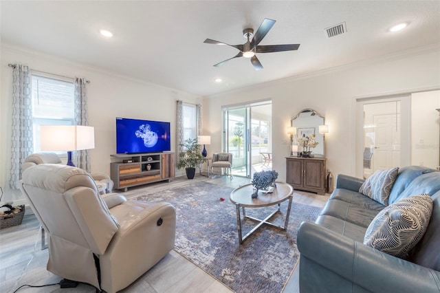 living area with visible vents, ornamental molding, a ceiling fan, and recessed lighting