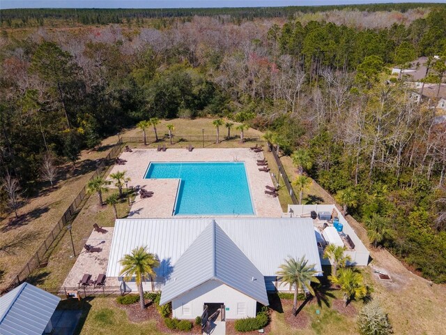 pool with a forest view and fence