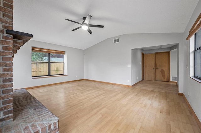 unfurnished living room featuring lofted ceiling, light wood finished floors, and visible vents