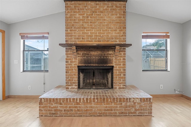 details with a fireplace, baseboards, and wood finished floors