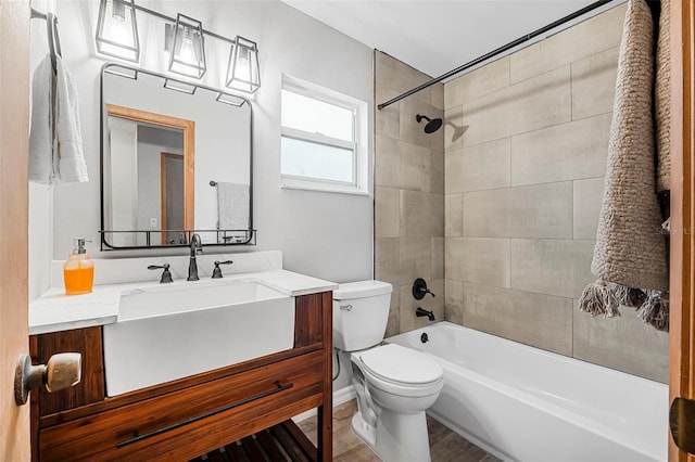 full bathroom with wood finished floors, vanity, toilet, and shower / bathtub combination