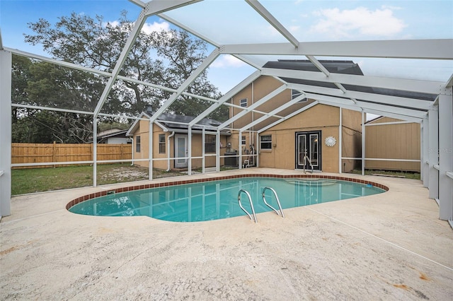 view of swimming pool with a fenced in pool, a lanai, a patio, and fence