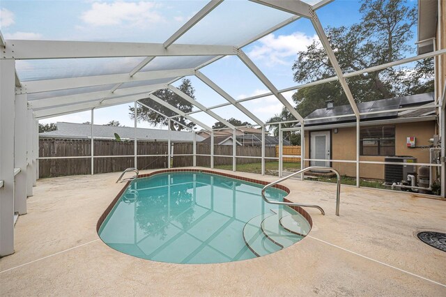 view of swimming pool featuring a patio, a fenced backyard, cooling unit, a lanai, and a fenced in pool