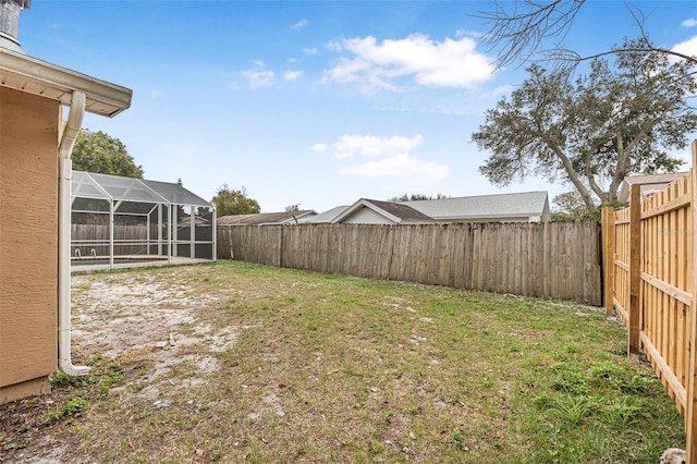 view of yard featuring a lanai and a fenced backyard