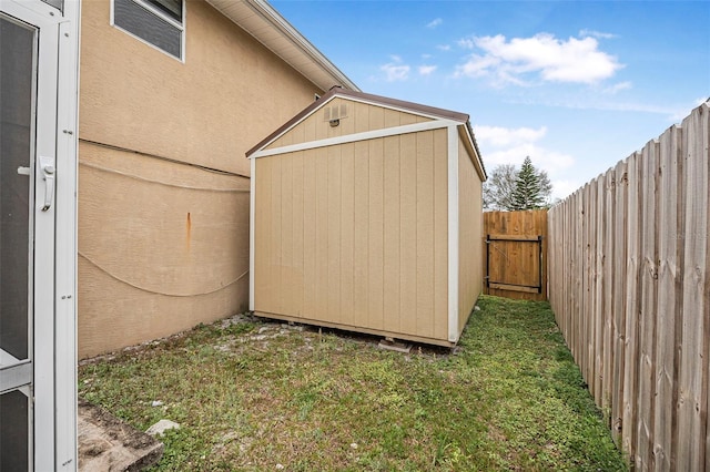 exterior space with a fenced backyard and a gate