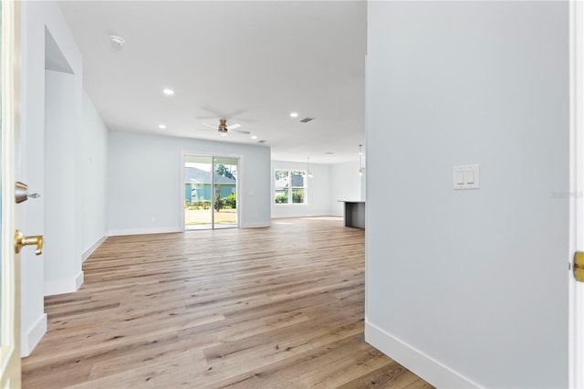 unfurnished living room with light wood-type flooring, baseboards, a ceiling fan, and recessed lighting