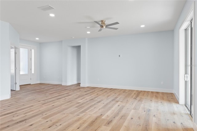 empty room featuring baseboards, light wood-type flooring, visible vents, and recessed lighting