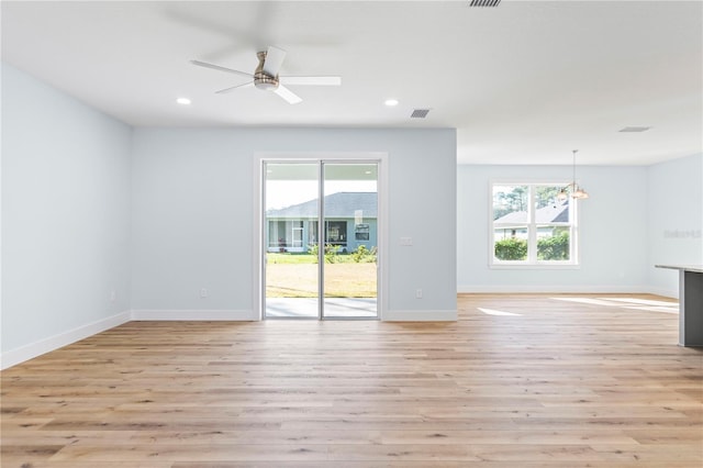 unfurnished living room featuring recessed lighting, baseboards, a healthy amount of sunlight, and light wood finished floors