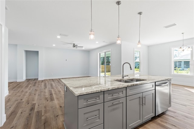 kitchen with a sink, visible vents, light wood-style floors, stainless steel dishwasher, and gray cabinets