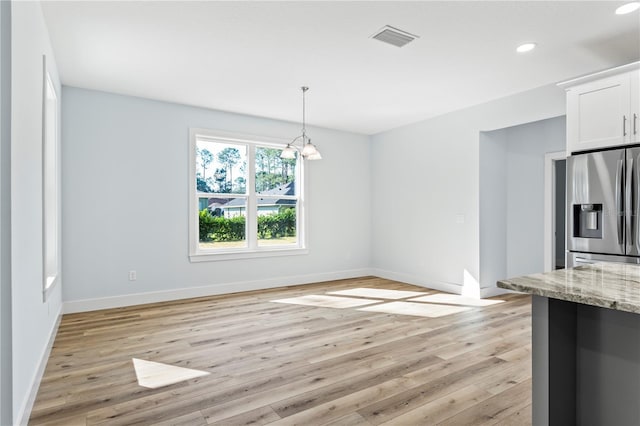 unfurnished dining area with light wood finished floors, baseboards, visible vents, a chandelier, and recessed lighting