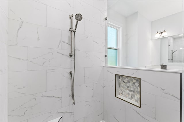 full bathroom featuring a marble finish shower