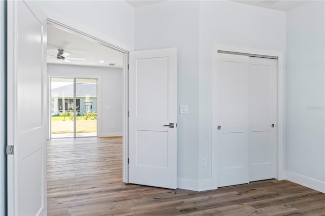 interior space featuring a closet, baseboards, and wood finished floors