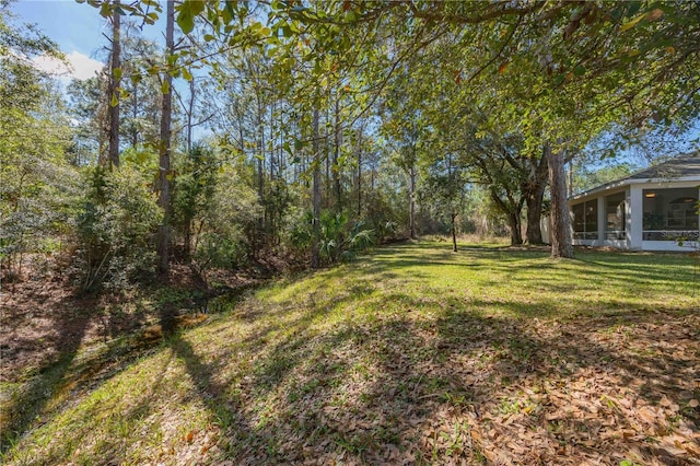 view of yard featuring a sunroom