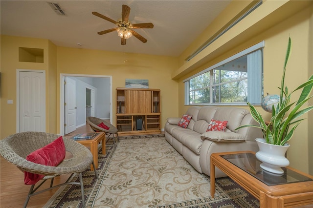 living area with light wood finished floors, visible vents, and a ceiling fan