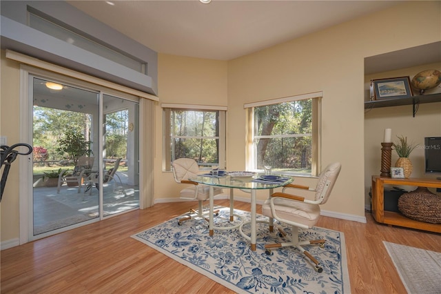 dining room featuring light wood-style floors and baseboards