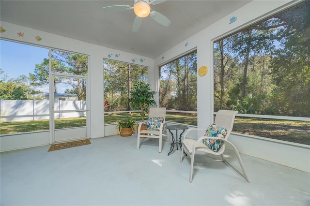 sunroom featuring a ceiling fan