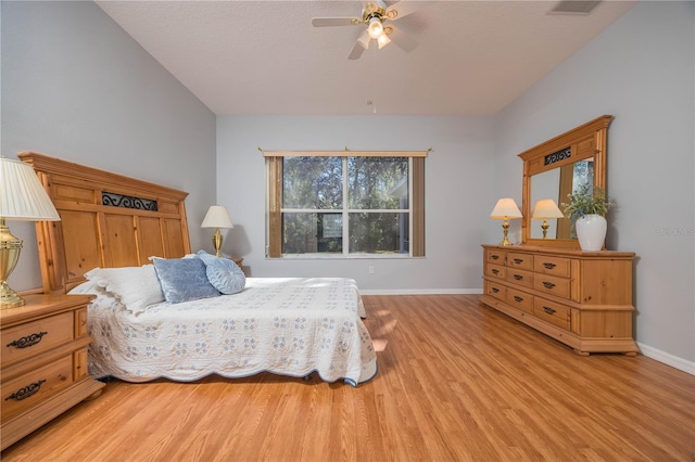 bedroom with light wood-style flooring, visible vents, baseboards, and a ceiling fan