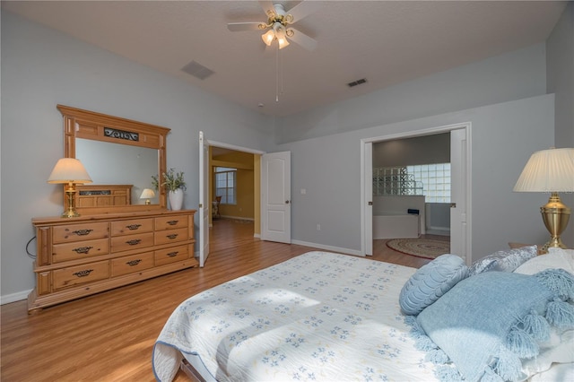 bedroom featuring light wood-type flooring, visible vents, and baseboards