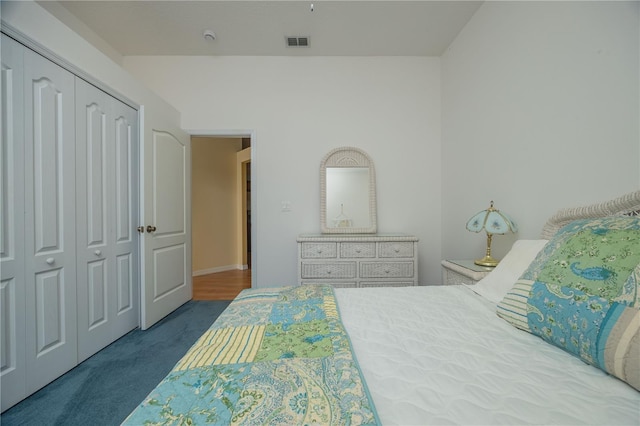 carpeted bedroom featuring a closet and visible vents