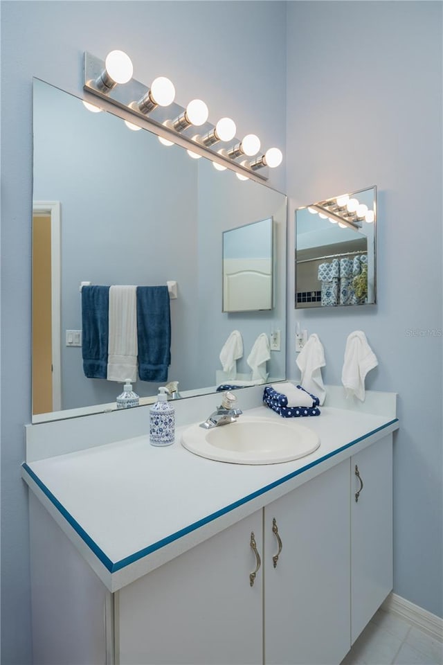 bathroom featuring baseboards and vanity