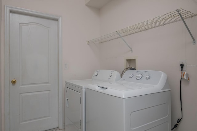 clothes washing area featuring laundry area and washer and dryer