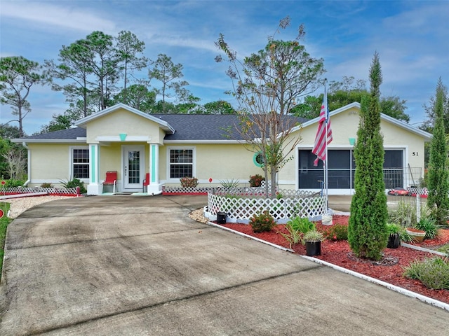 ranch-style home with a shingled roof and stucco siding