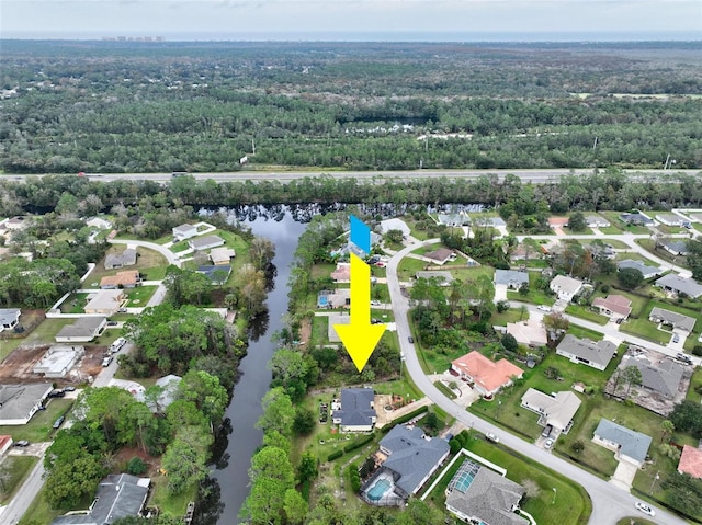 birds eye view of property with a water view and a residential view