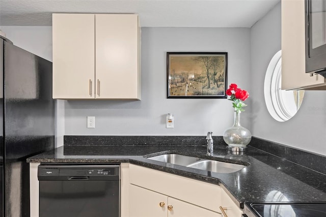 kitchen featuring black appliances, dark stone counters, and a sink