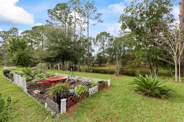 view of yard with a water view and fence