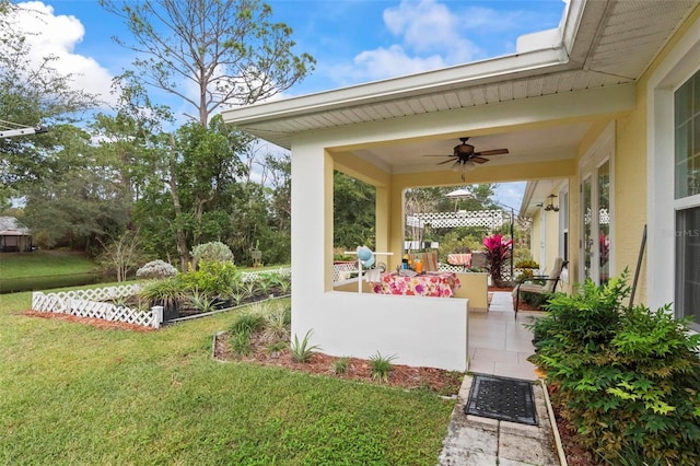 view of yard featuring a patio area and ceiling fan