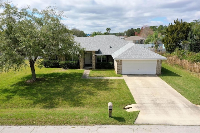 ranch-style home with brick siding, a shingled roof, concrete driveway, an attached garage, and a front yard