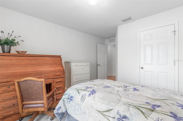 bedroom featuring visible vents and a textured ceiling