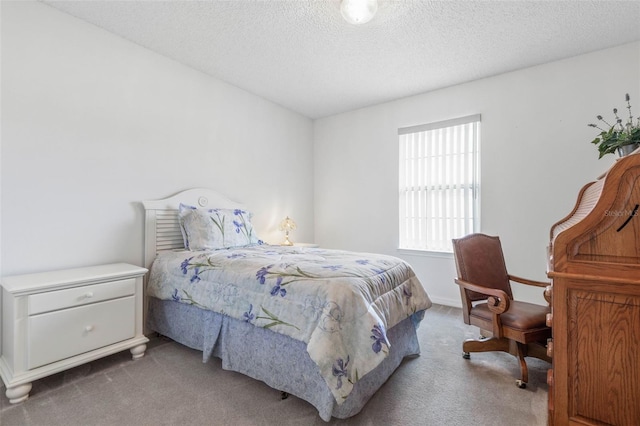 bedroom with a textured ceiling and carpet flooring