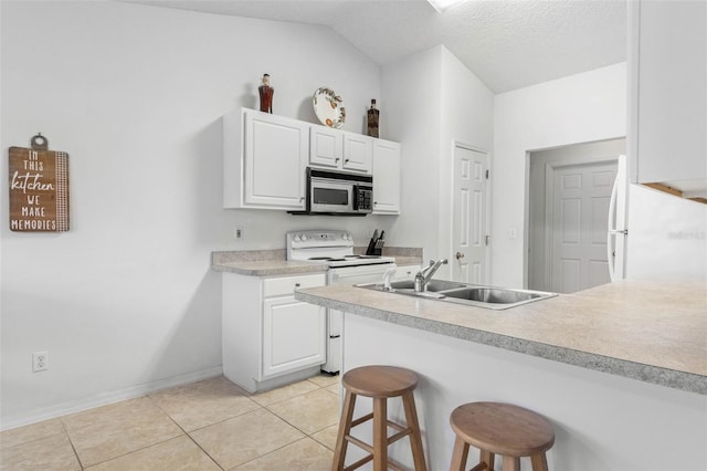 kitchen featuring light countertops, white appliances, a sink, and white cabinetry