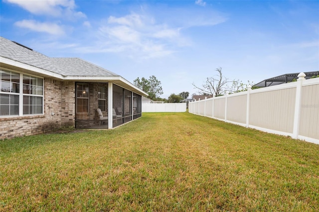 view of yard with a fenced backyard and a sunroom