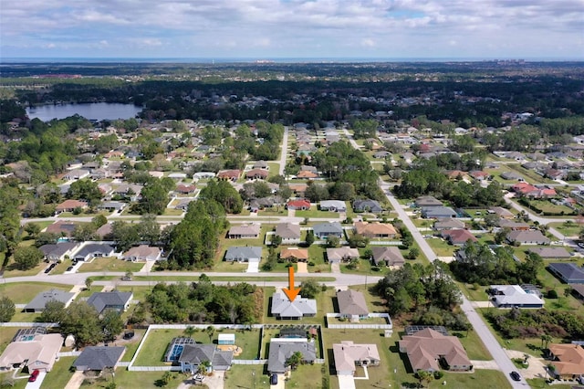 drone / aerial view featuring a water view and a residential view