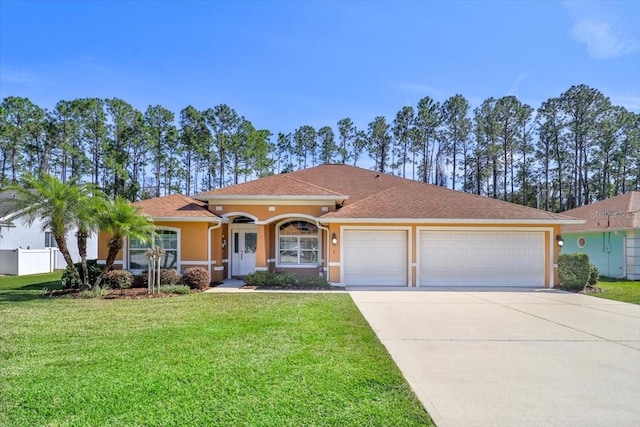 view of front of home featuring driveway, a garage, a front lawn, and stucco siding