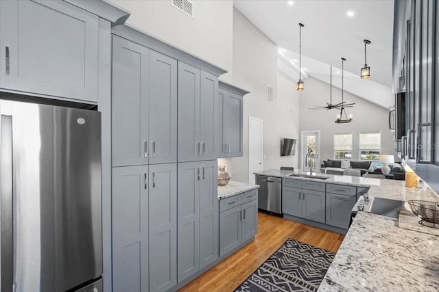 2737 John Bull, Flagler Beach, FL 32136 - kitchen featuring gray cabinets, stainless steel appliances, a sink, and open floor plan