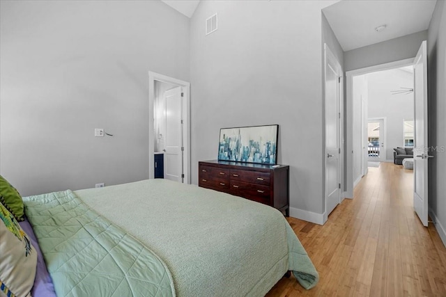 2737 John Bull, Flagler Beach, FL 32136 - bedroom featuring light wood-style floors, lofted ceiling, and baseboards