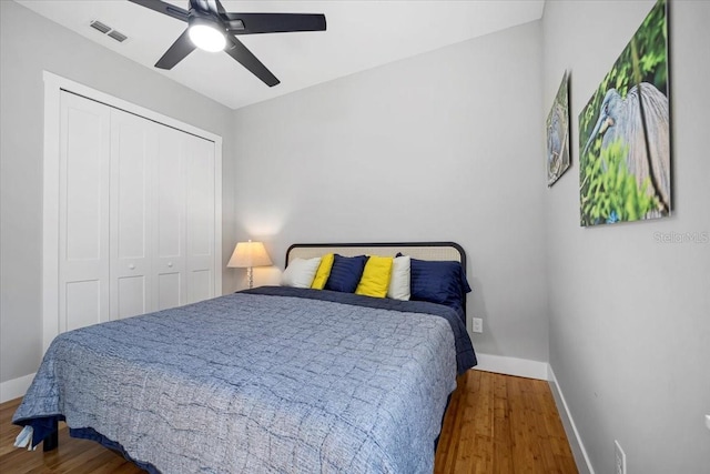 2737 John Bull, Flagler Beach, FL 32136 - bedroom with baseboards, a closet, visible vents, and wood finished floors