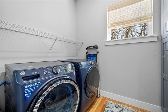 2737 John Bull, Flagler Beach, FL 32136 - laundry room featuring laundry area, separate washer and dryer, wood finished floors, and baseboards