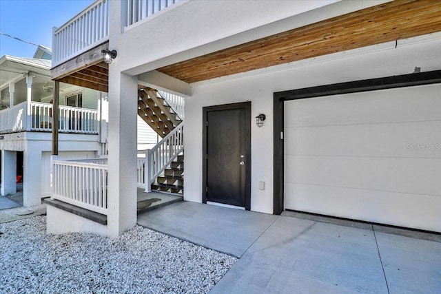 2737 John Bull, Flagler Beach, FL 32136 - doorway to property featuring a garage and stucco siding