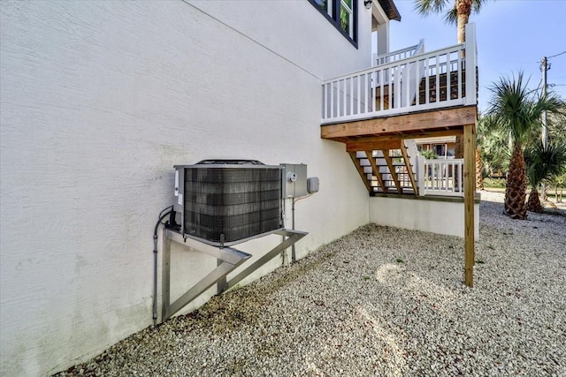 2737 John Bull, Flagler Beach, FL 32136 - view of side of home featuring stucco siding and central AC unit