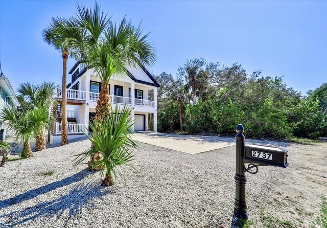 2737 John Bull, Flagler Beach, FL 32136 - beach home featuring concrete driveway and an attached garage