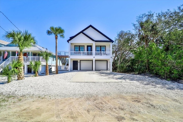 2737 John Bull, Flagler Beach, FL 32136 - beach home featuring a garage, concrete driveway, and stairway