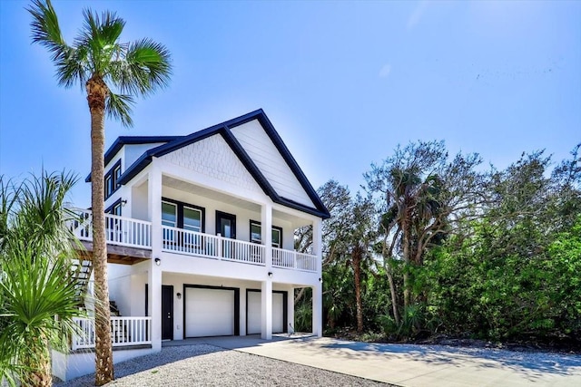 2737 John Bull, Flagler Beach, FL 32136 - beach home featuring driveway, covered porch, an attached garage, and stucco siding