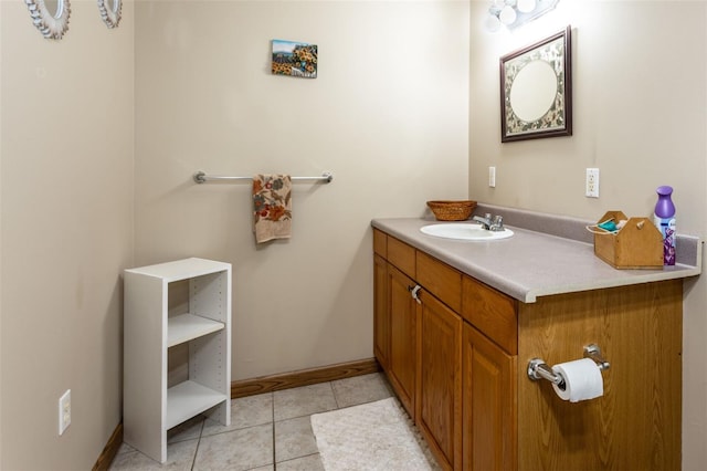 bathroom featuring vanity, baseboards, and tile patterned floors