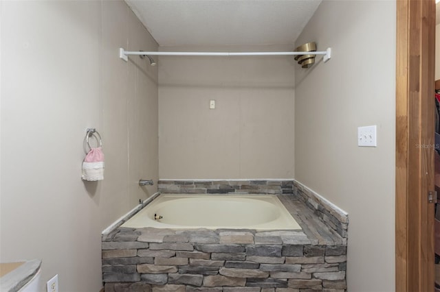 full bathroom featuring a textured ceiling and a bathtub