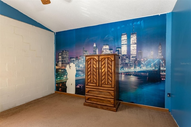 unfurnished bedroom with vaulted ceiling, carpet, and a ceiling fan